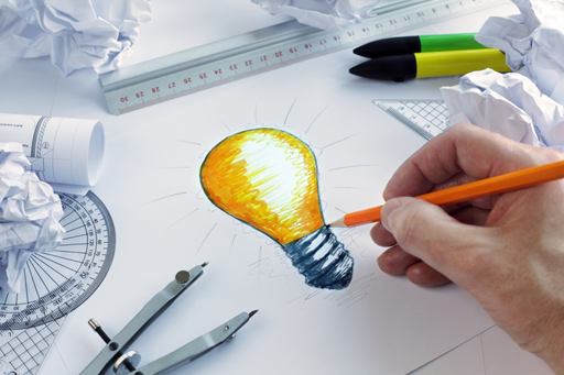 Inventor outlining concept design on whiteboard